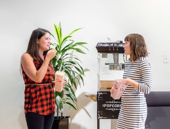 Two girls eating popcorn